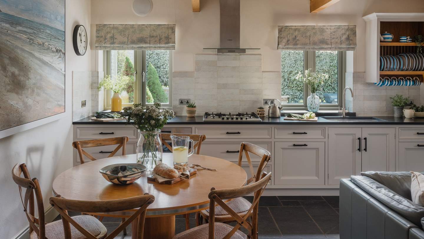 The stylish bespoke kitchen with granite work surfaces and hand-crafted cupboards are fully equipped with all that you'll need to rustle up a feast