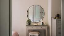 The sweet dressing table and round mirror is perfect for moments of self-care