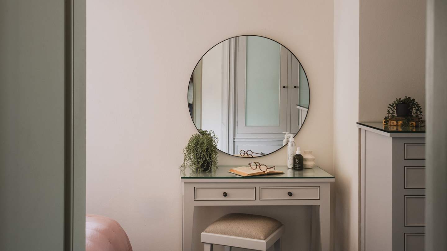 The sweet dressing table and round mirror is perfect for moments of self-care