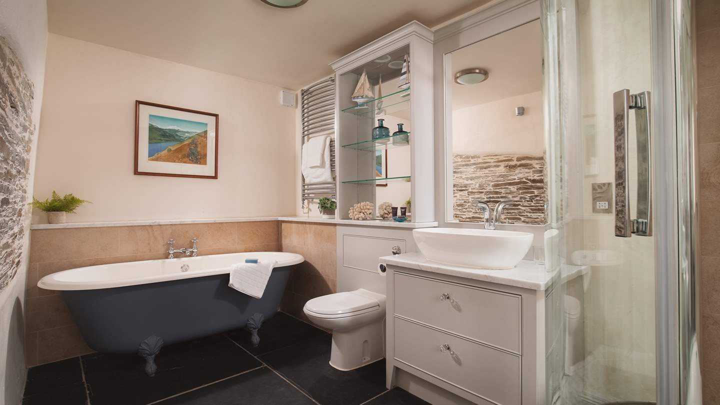 The family bathroom boasts a fabulous free-standing roll-top bath for long, luxurious soaks as well as a walk in shower.