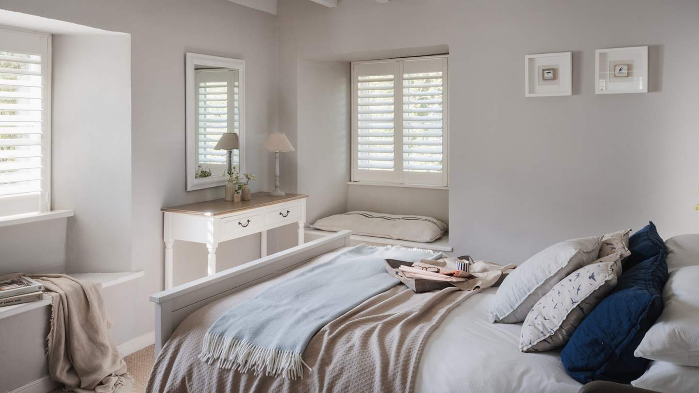 You'll find a charming dressing table along with a pretty window seat... 