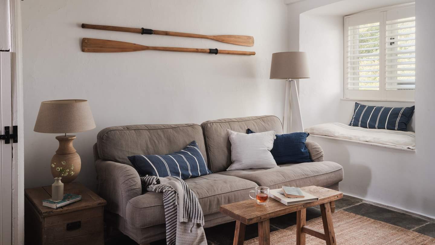 Offering irresistible comfort is a two-seater sofa in mocha and snug window seat