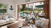 The open-plan kitchen/dining room brings the outside in during warmer weather