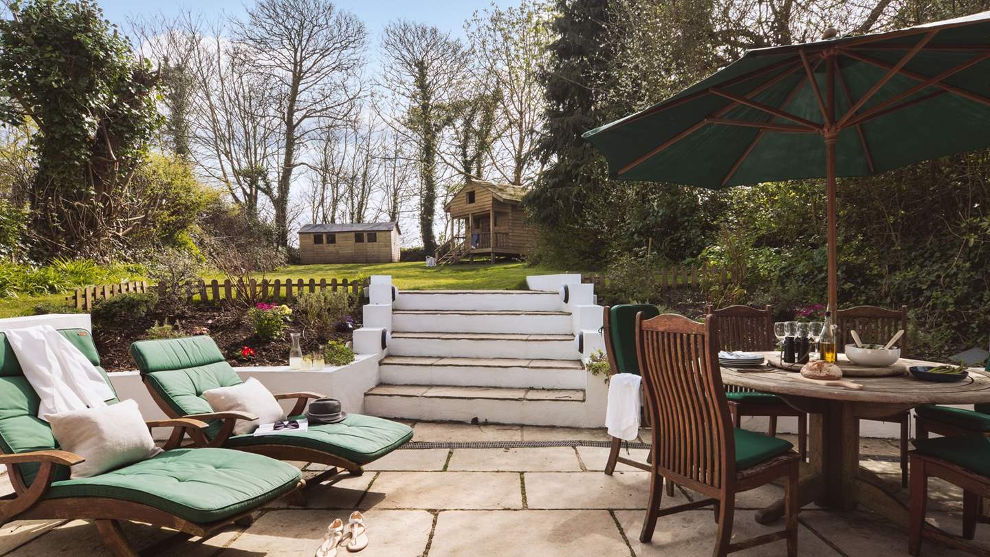 The patio comes complete with dining table and chairs, plus sun loungers