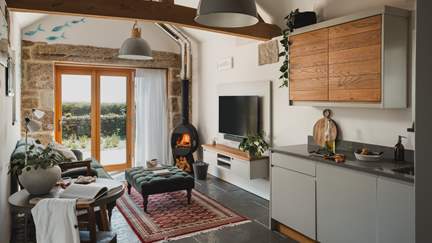 The epitome of cosiness, you’ll find a wood burning stove, with large bi-fold doors in both the open plan living, eating and dining space