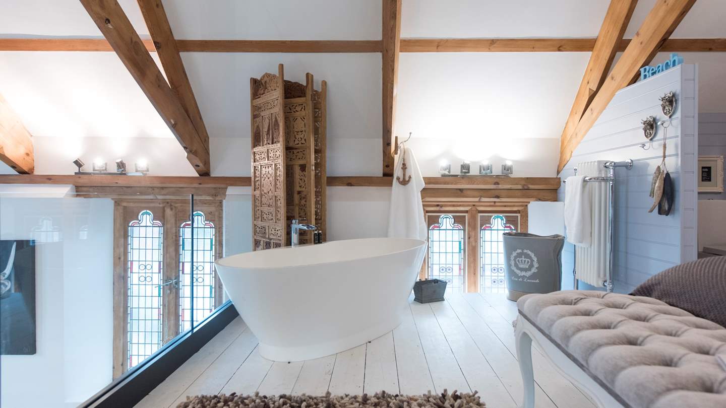 The pièce de résistance is the fab freestanding bathtub for two which overlooks the chapel below.