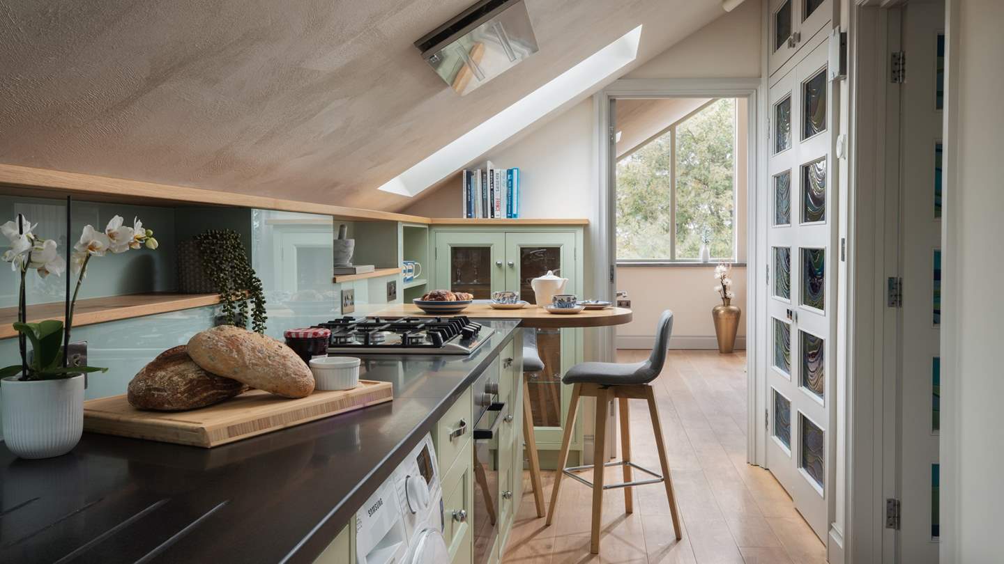 The cute galley kitchen is fully kitted out with everything you need to whip up a meal or two