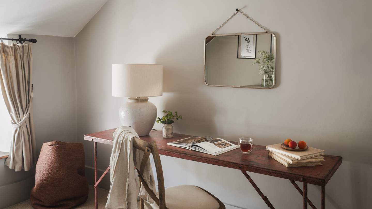 A vintage  writing desk lends space for journaling 