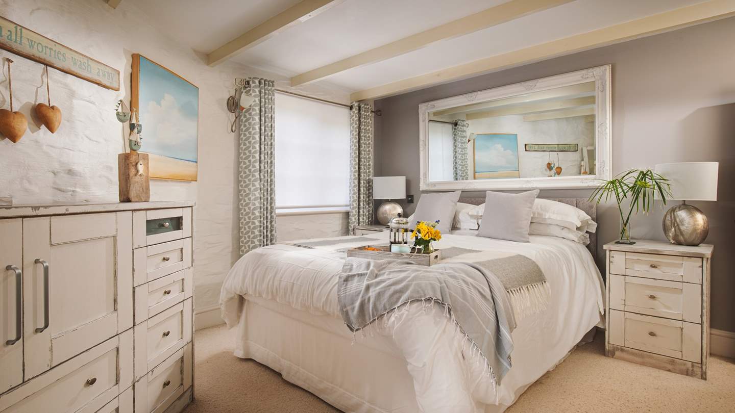 At the end of the day, withdraw to the delightful master bedroom where you'll find a laid-back-yet-lovely space to unwind