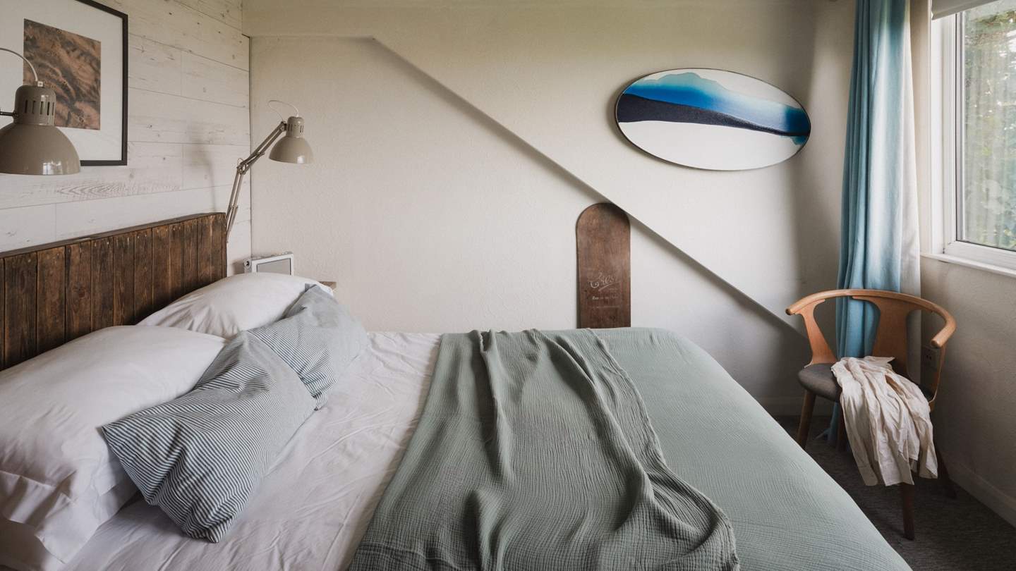 Also on the first floor, the final bedroom is decorated in soft tones of grey, blue and white 
