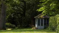 We just love this pretty summerhouse, overlooking the beautiful trees and lawn.