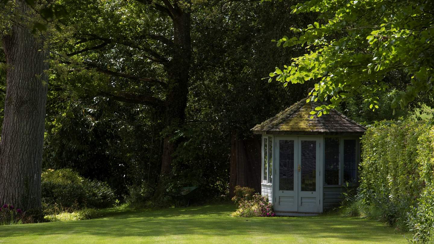We just love this pretty summerhouse, overlooking the beautiful trees and lawn.
