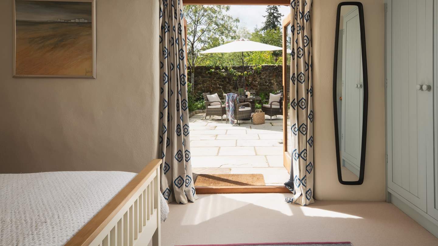 With french windows that lead into the garden, you can let the summer night breezes help you drift off to sleep.