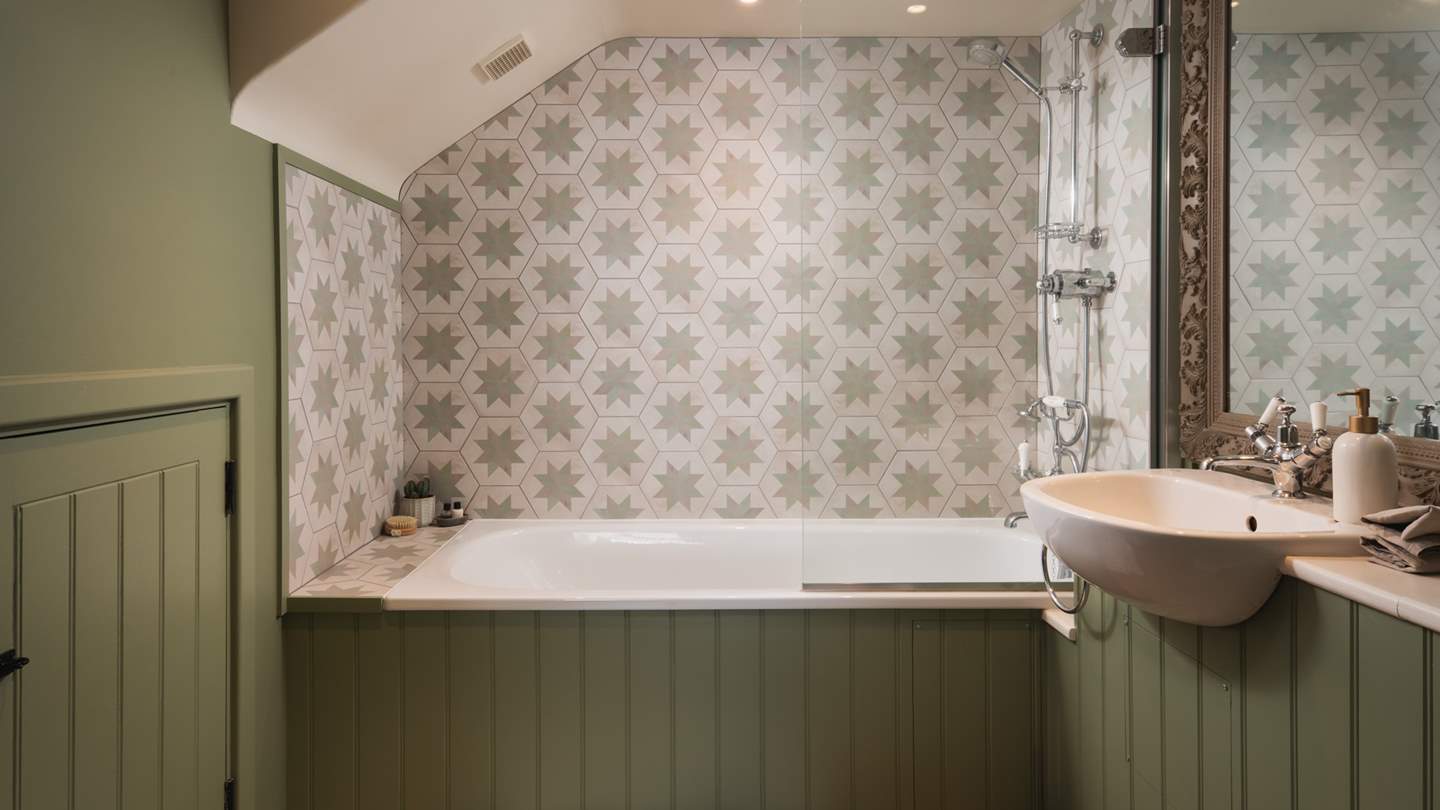 The beautiful bathroom, complete with a large antique mirror 