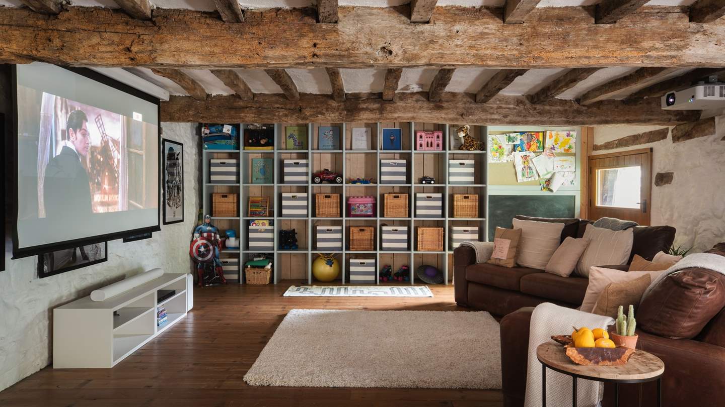 The beamed Games Barn is an incredible space with entertainment for the whole family, including a TV with a surround sound system for delightful movie nights 
