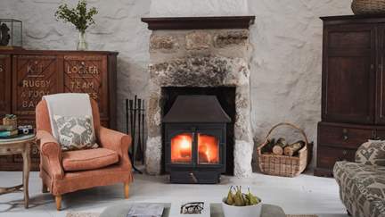 Taking centre stage, the handsome wood-burning stove is the heart of the home