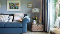 The pretty living area is a tranquil space in shades of blue and cream