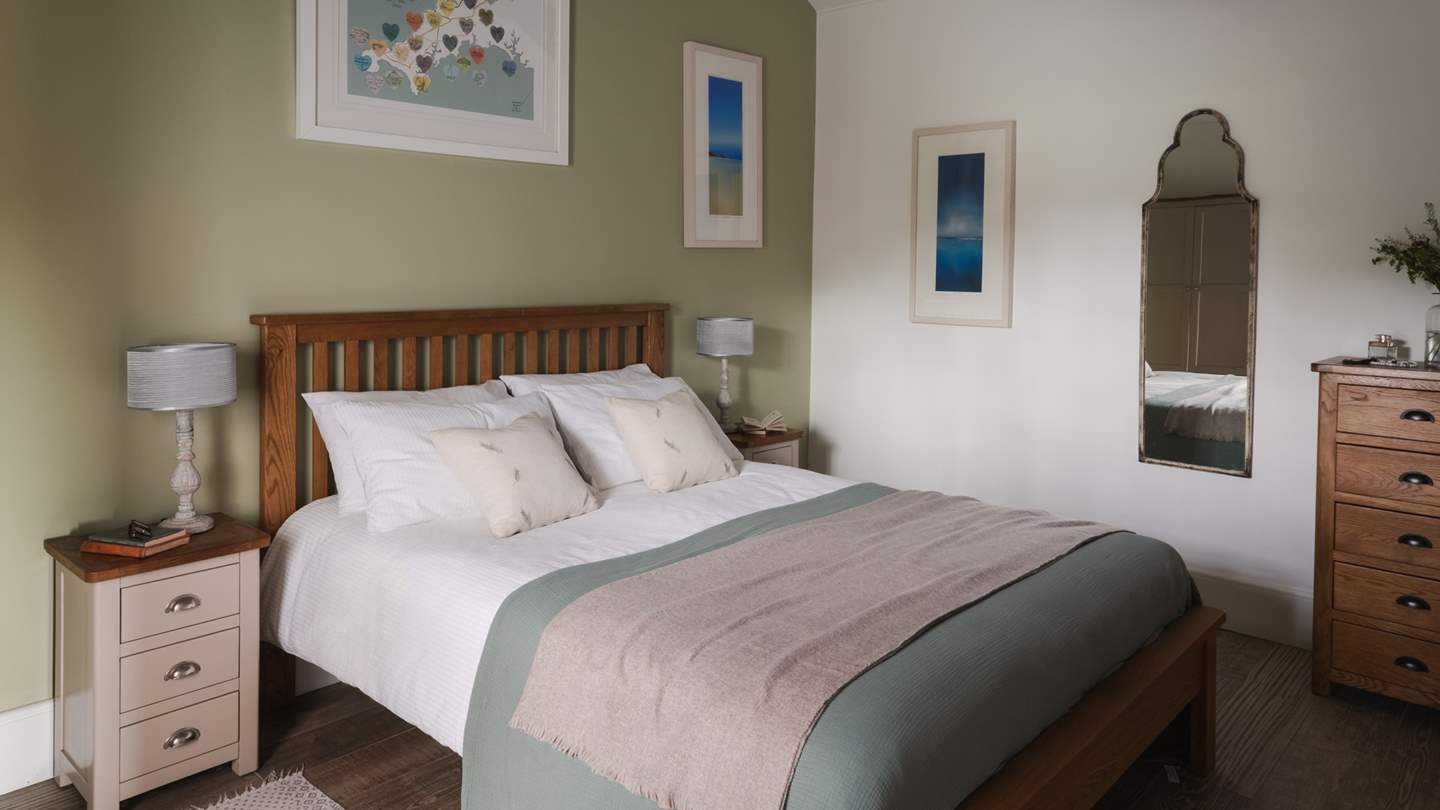 The stunning bedroom is beautifully romantic in shades of white and green