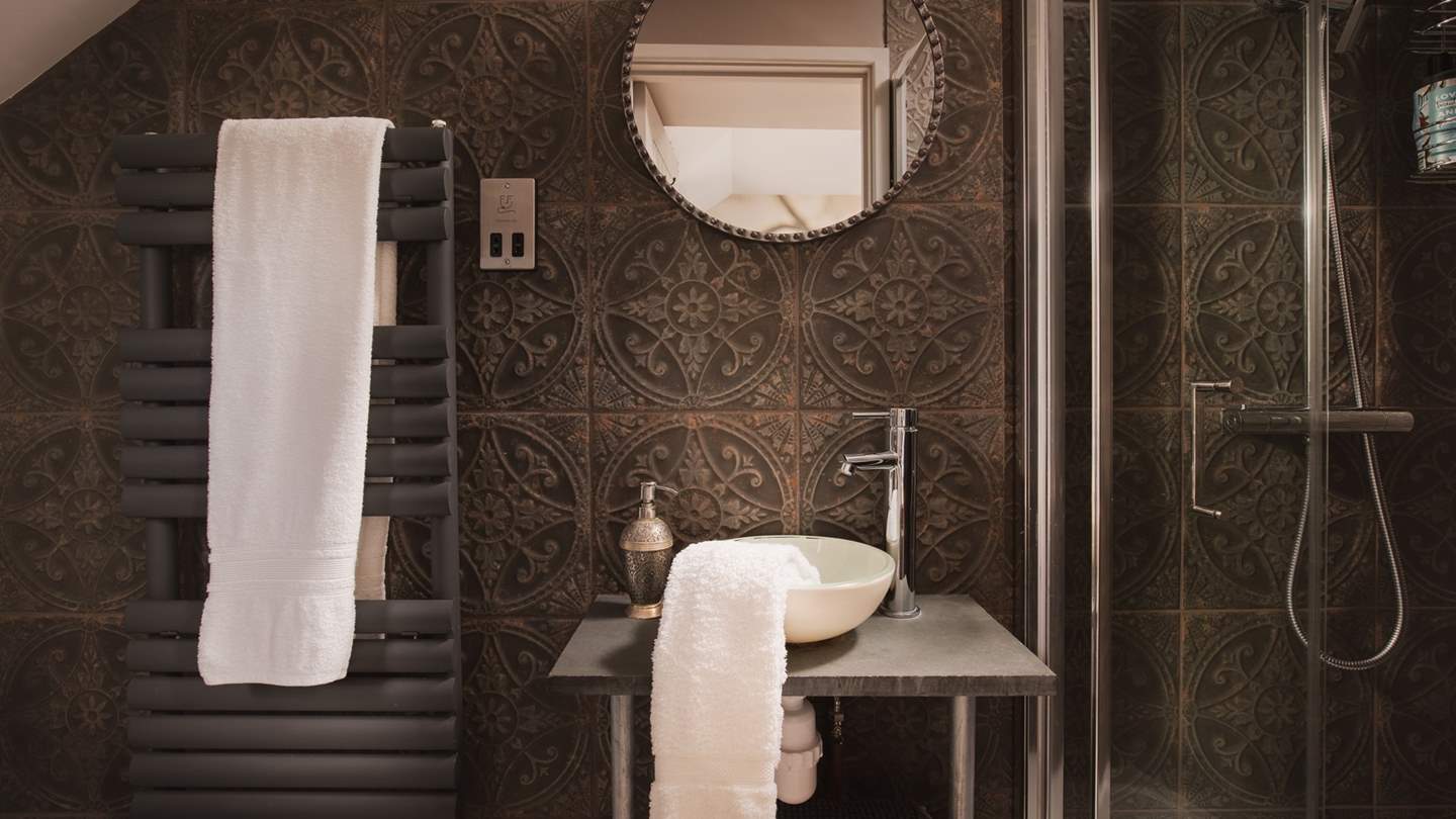 The en-suite with a walk-in shower for refreshing wake-me ups and pretty tiles inspired by faraway shores... 