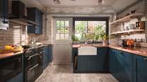 With gorgeously rich copper work tops, dark blue cupboards and whitewashed brick walls, this is a super-stylish kitchen.