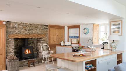 The pretty wood burner is a wonderful addition to the pretty country kitchen.