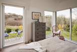 The floor-to-ceiling windows in the bedroom offers a panoramic view from the comfort of your bed