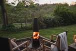 Outside you'll find a decking area complete with deckchairs and a table and chairs, a fire pit, and a gas barbecue - perfect for a spot of al fresco dining