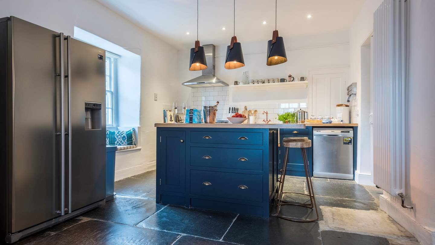 At the far end lies the kitchen area, complete with original flag flooring