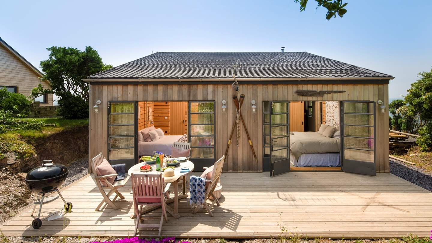 This corker of a retreat is a super-luxe cabin - Step out of the bedrooms onto the rear deck for breakfast al fresco.