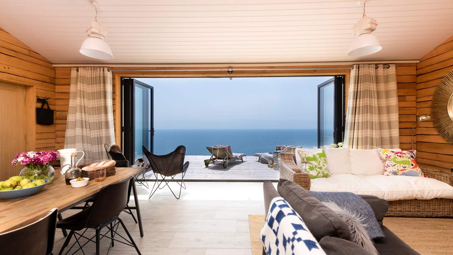 The stunning open-plan living space certainly makes the most of the unique views, with bi-fold glass doors that open out on to the large terrace overlooking the sea. 