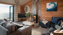 High ceilings, rugged wooden walls and floors add to the naturally nautical feel, whilst the wood burner, underfloor heating and soft lighting add cosiness