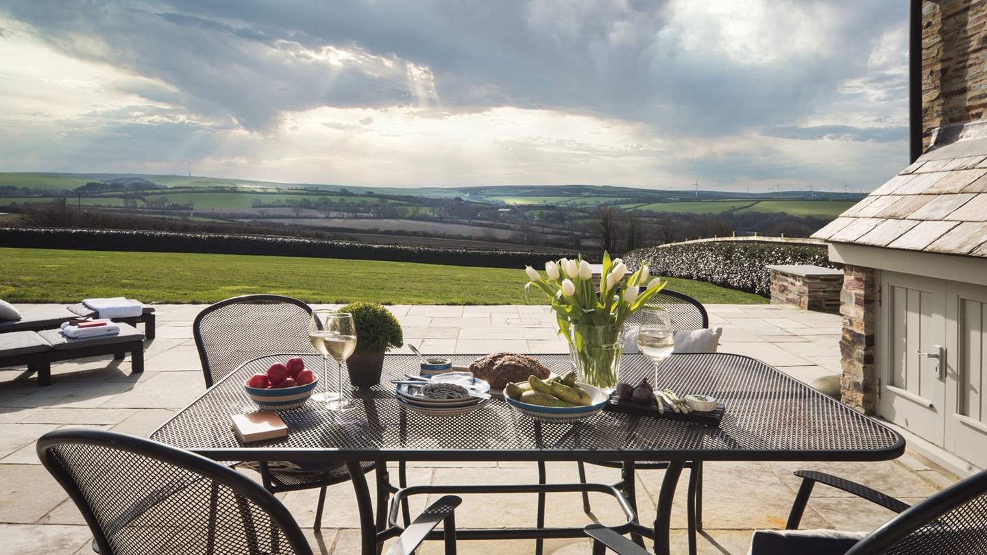 A step leads outside from the bi-folding doors and Trevear Lodge is encircled by a lovely stone terrace