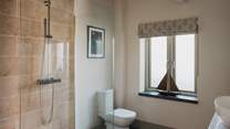 The en suite benefits from a large walk in rainfall shower for refreshing wake-me ups 