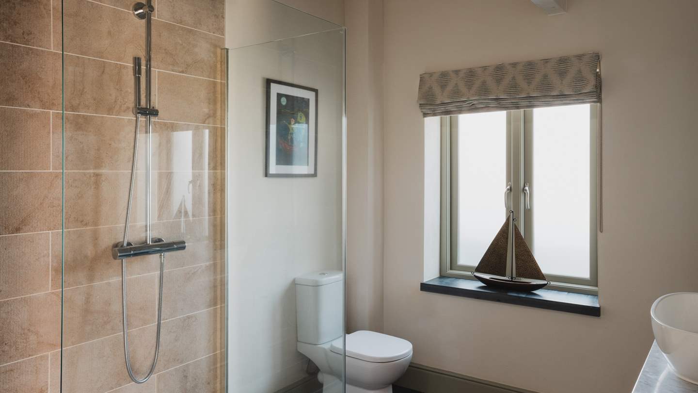 The en suite benefits from a large walk in rainfall shower for refreshing wake-me ups 