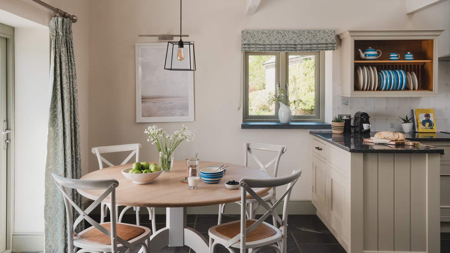 The dining table for four is perfectly nestled by the window to make the most of the glorious views
