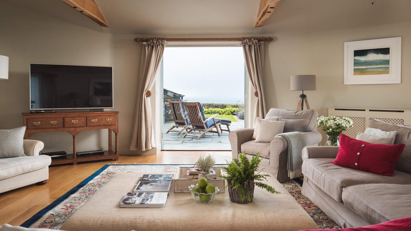 The French doors from the Milling Barn lead out to a private terrace with surrounding Cornish stone hedges (walls)