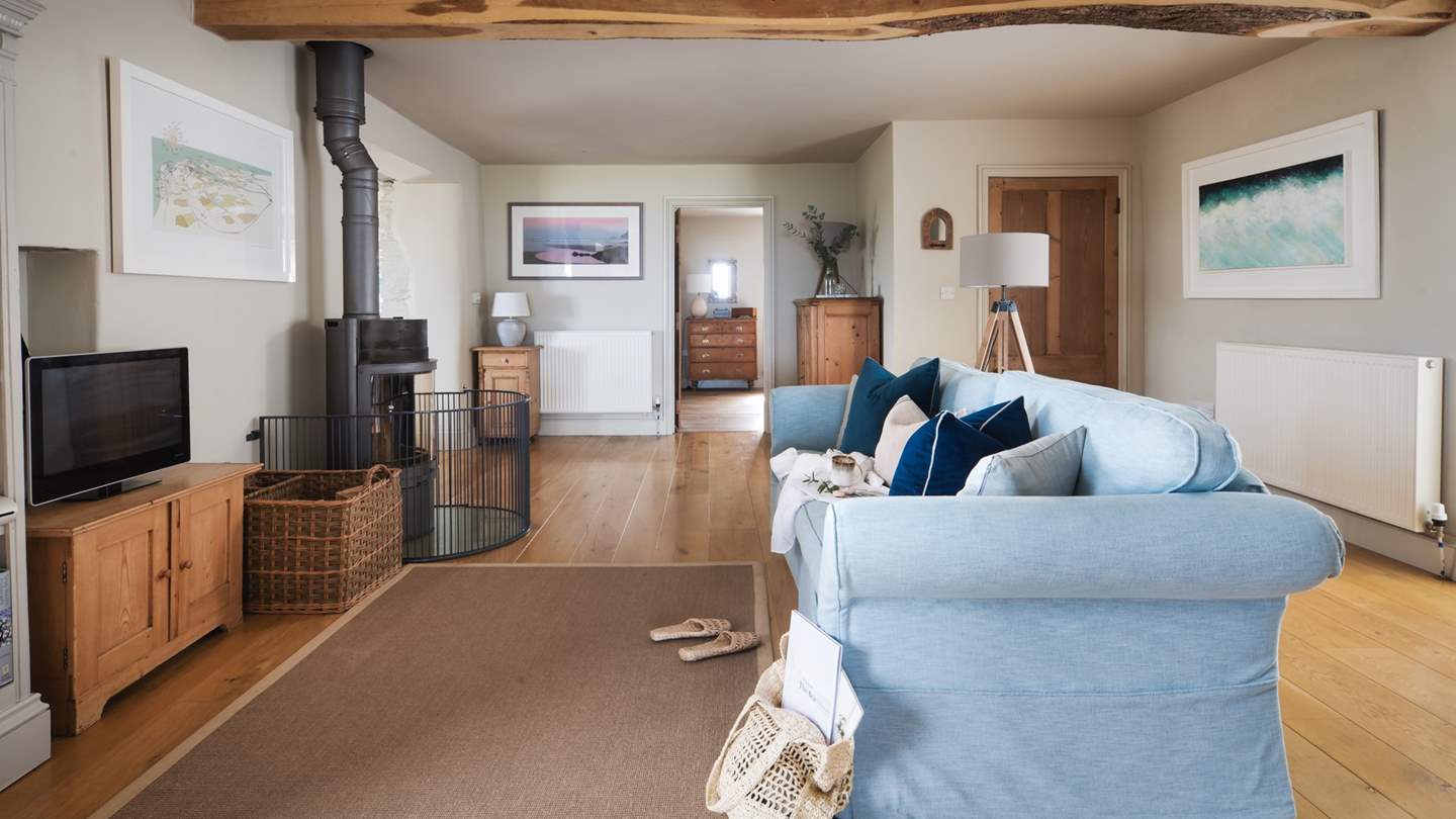 The Milling Barn leads into the second living space, an open-plan room featuring a large Scan wood burning stove and sofa