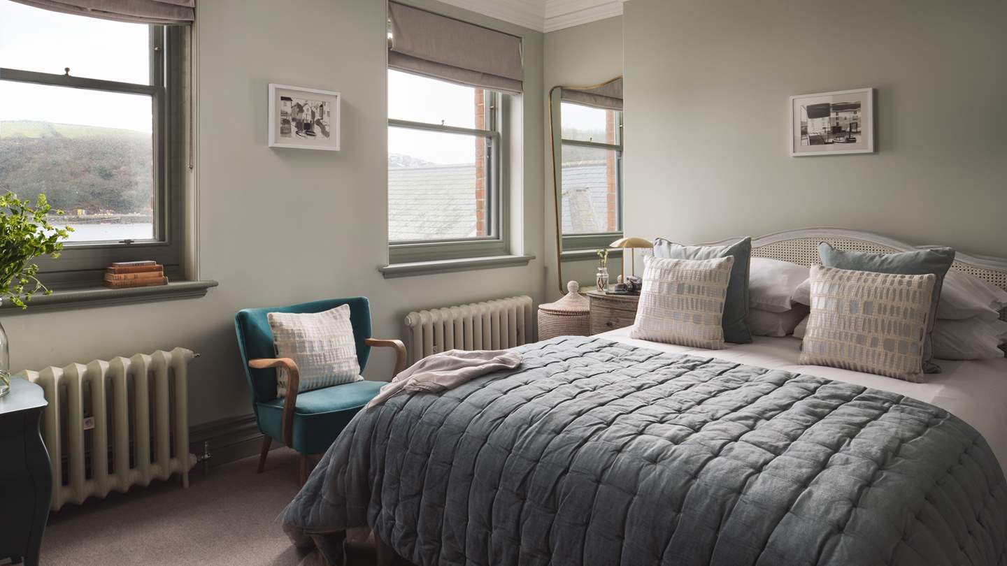 The lovely master bedroom is complete with a sumptuous king-sized bed