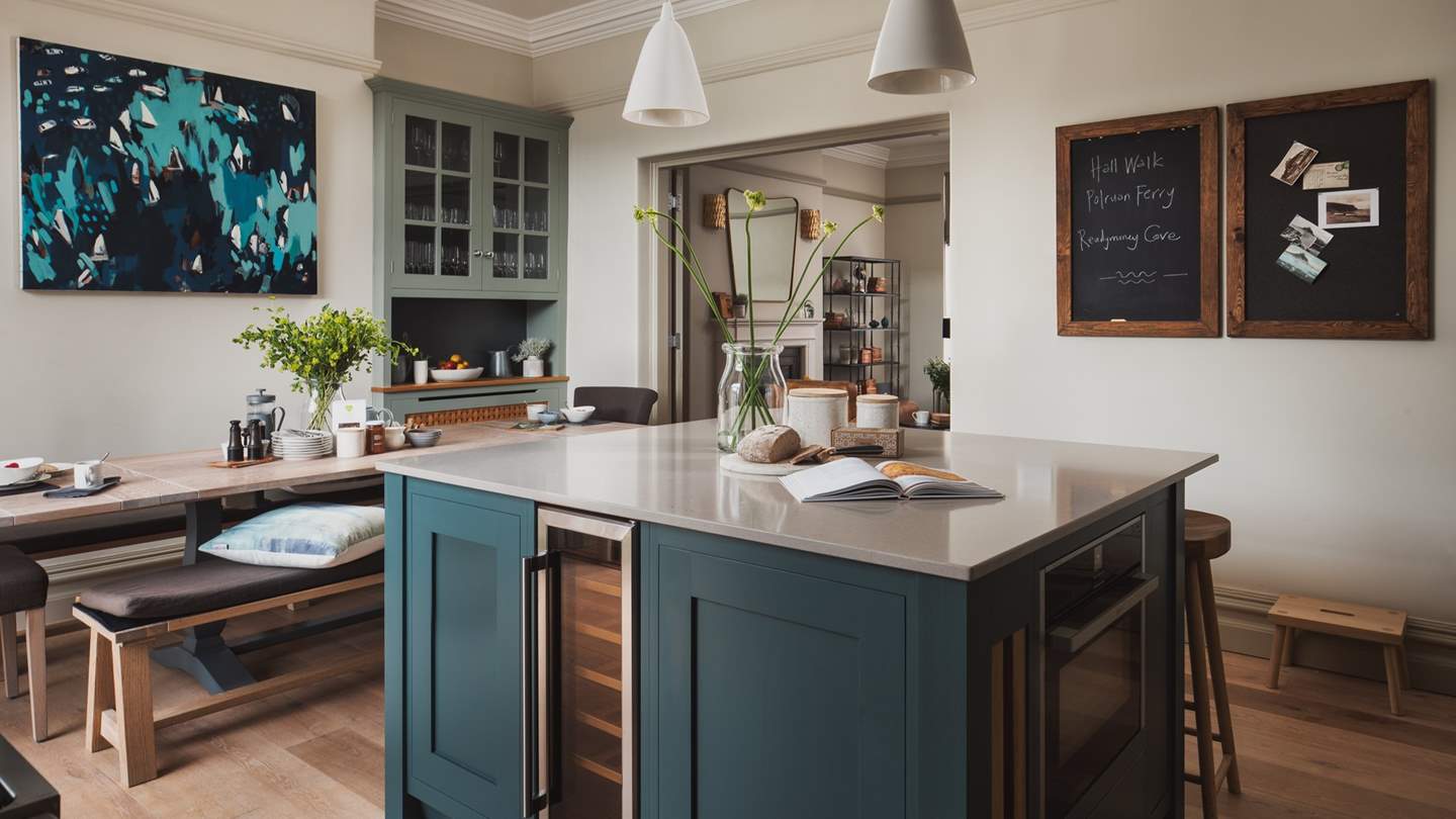 The beautiful Neptune dining table, set in the main kitchen, perfectly seats twelve and looks out over the water and hills beyond
