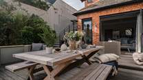 The spacious deck area is brimming with spaces to settle and enjoy sun-soaked alfresco dining