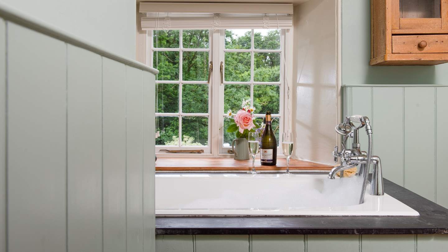 The family bathroom, panelled with wood, is a perfect spot for lying in bubbles.