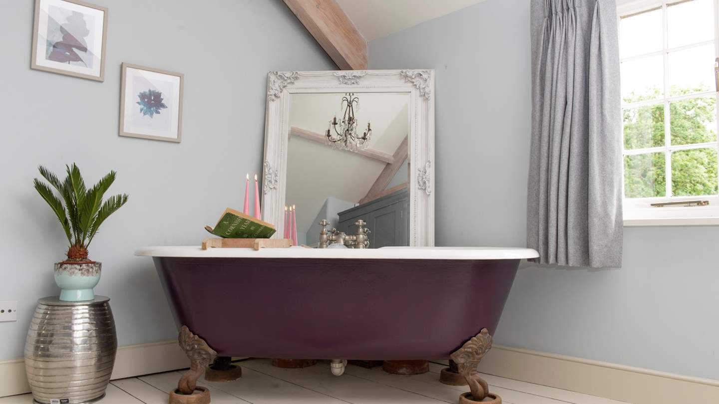 The dreamy roll top bath set at the foot of the master bed.
