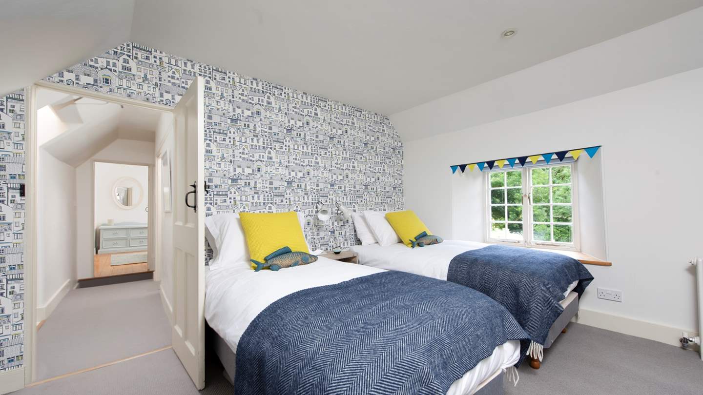 The third bedroom with a super kingsize zip-and-link bed which can also be made into twin beds. We just love the eye-catching St Ives wallpaper in this charming room.