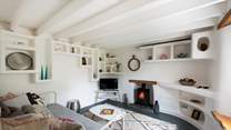 The second sitting room is a super-cute snug with whitewashed walls and eye-catching shelving housing lots of curious.