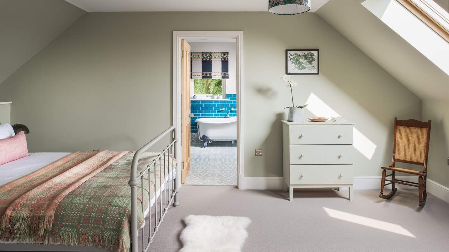 This bedroom has a beautiful ensuite bathroom, with a rolltop bath and separate walk-in shower 