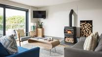  The pretty sitting area has a stunning, modern wood burner at its heart