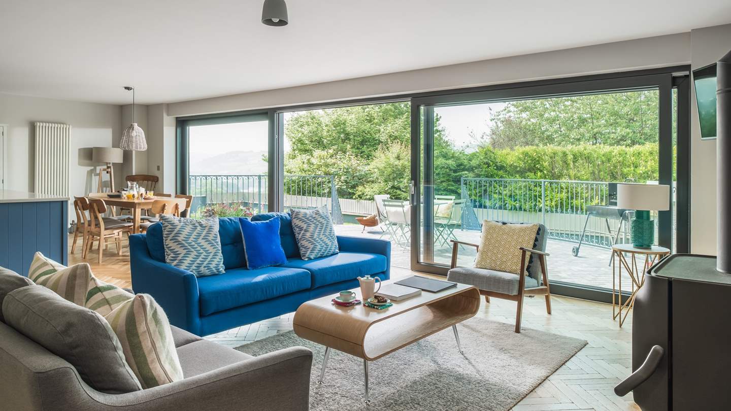 Floor-to-ceiling glass windows flood the room with beautiful natural light 