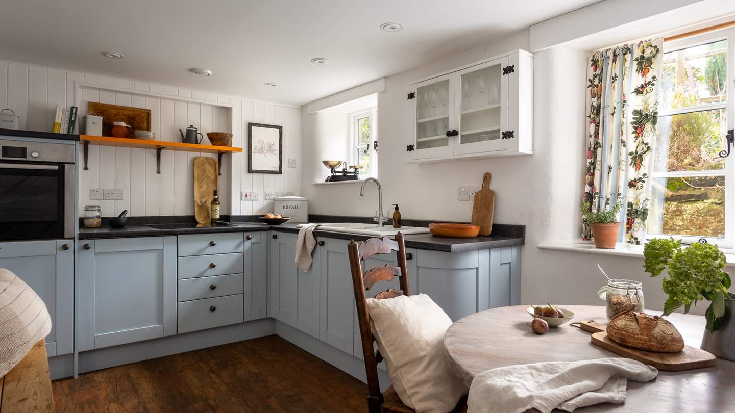 A elegantly rustic kitchen can be found at the back of the retreat overlooking the pretty garden