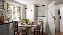 The round dining table at the far end of the kitchen is made for intimate meals