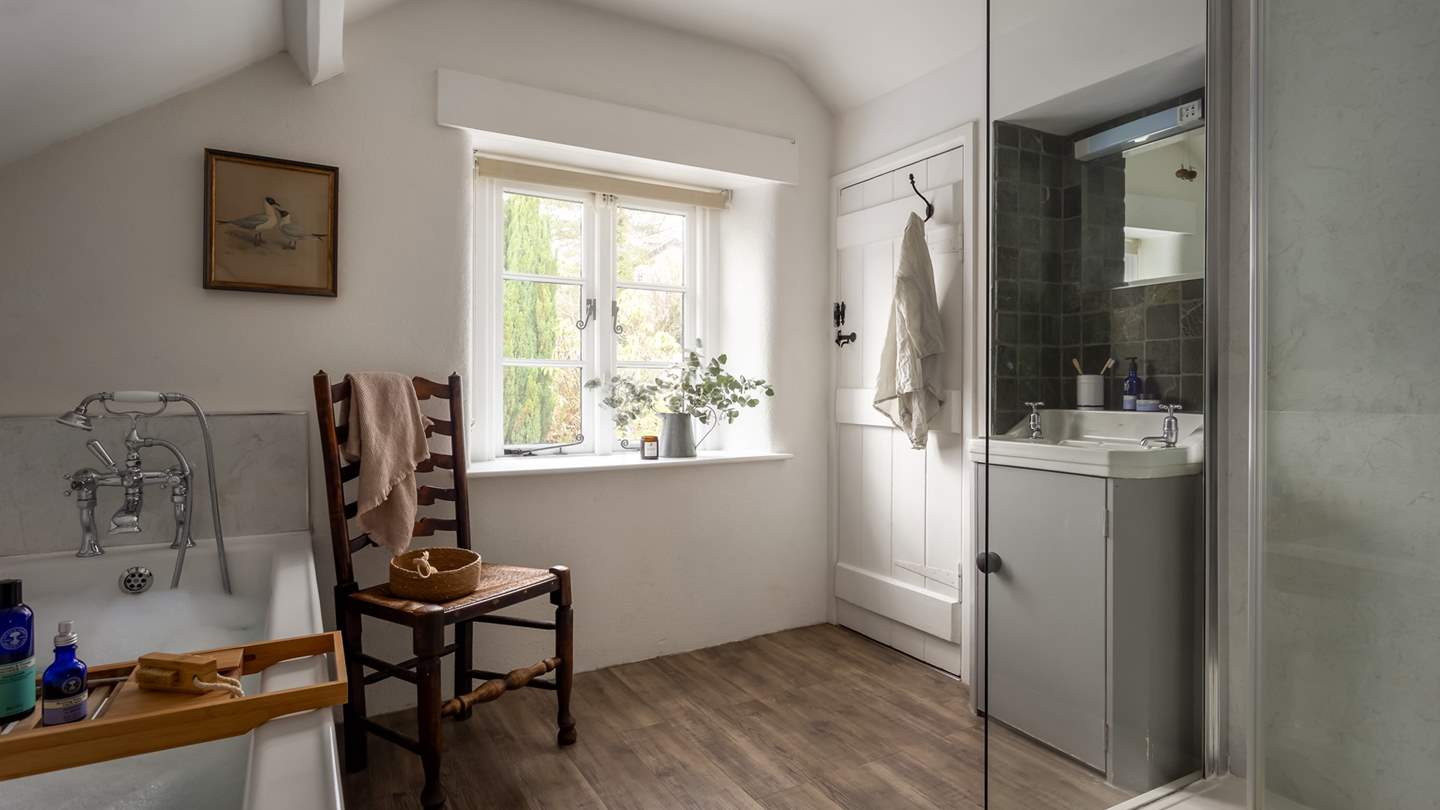The en suite bathroom with 'Jack and Jill' doors, is home to a large walk-in rainfall shower and a separate bath for leisurely soaks
